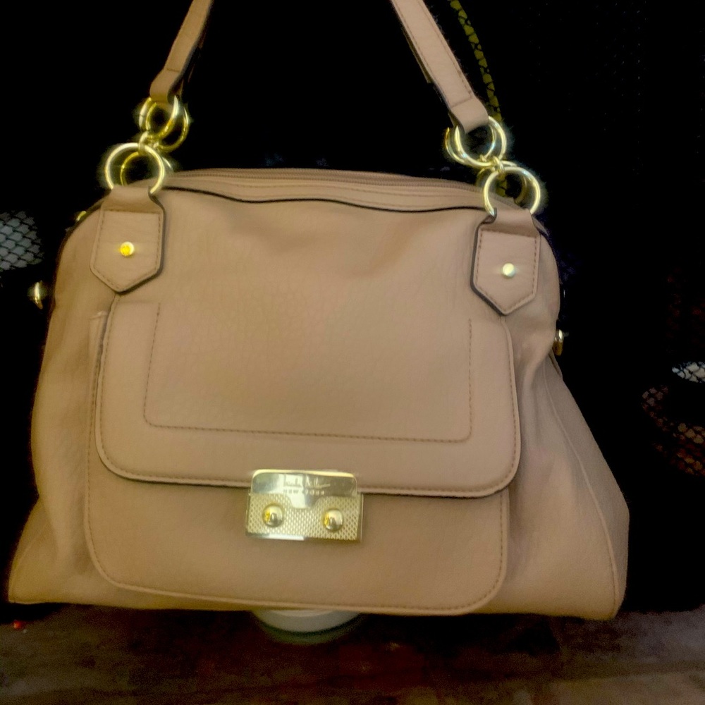 Cream colored purse with gold hardware